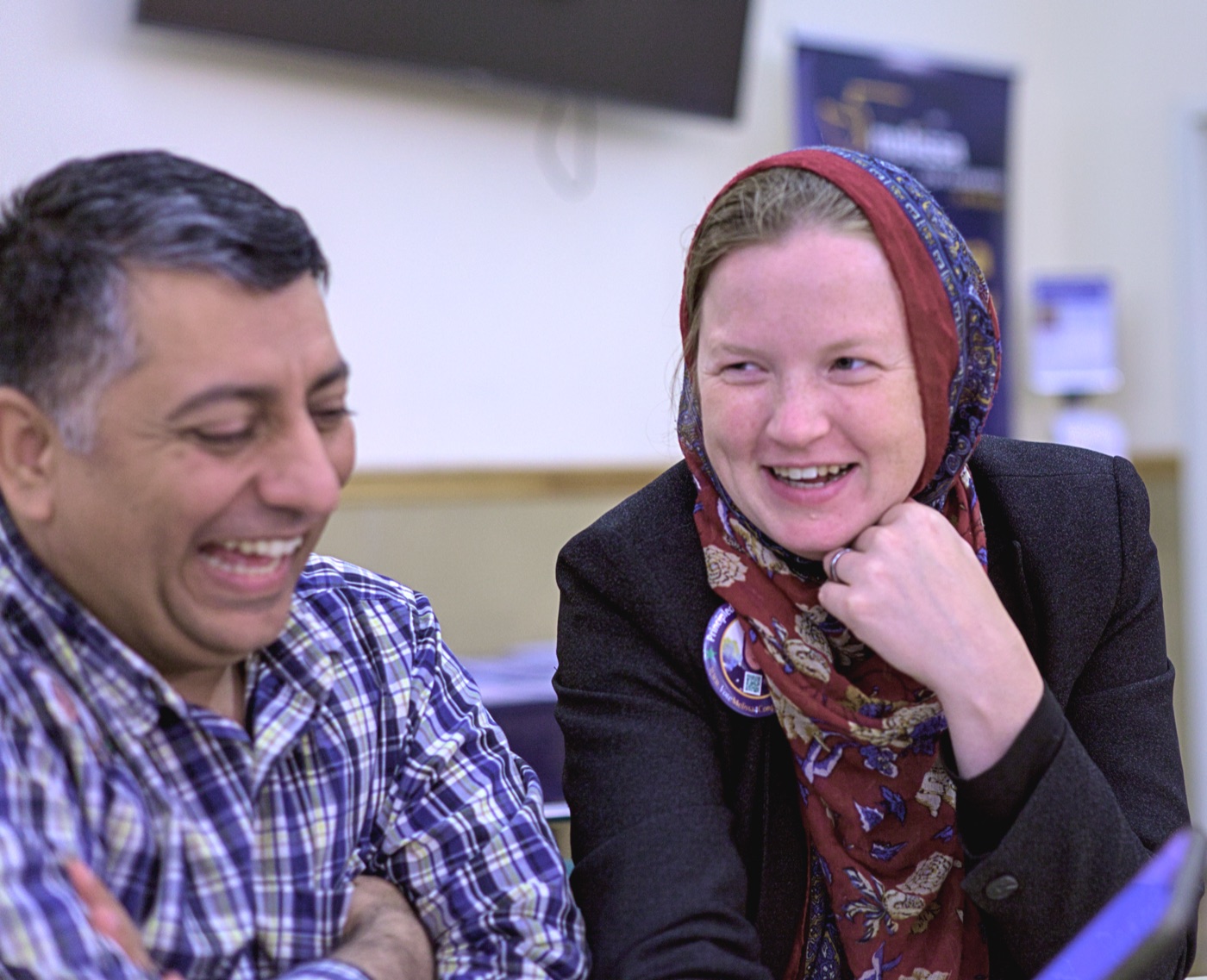Zahid and Melissa Chaudhry laughing together at a community event.